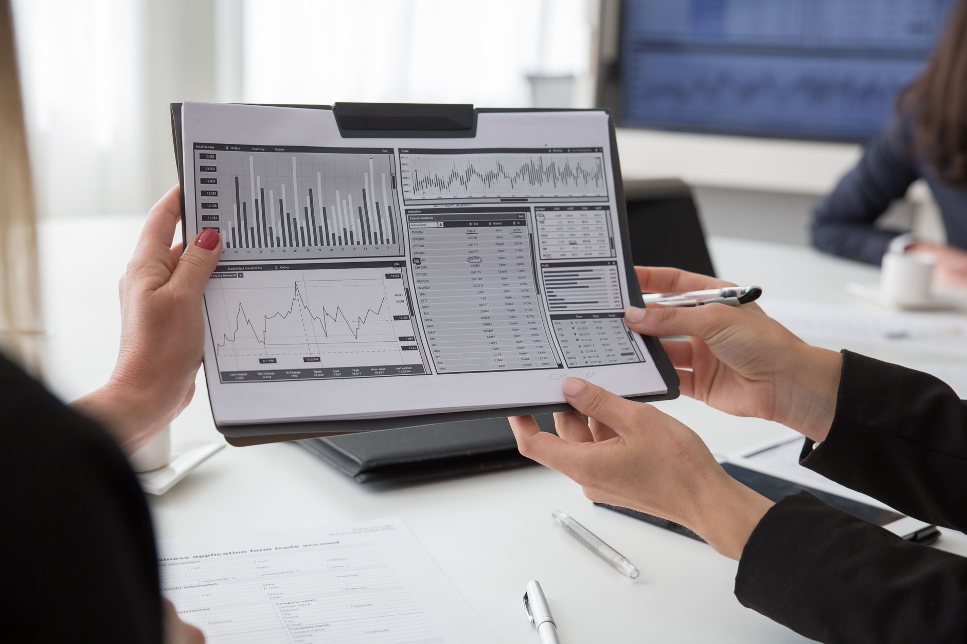 Media analysts looking at statistics on high tech computer screen