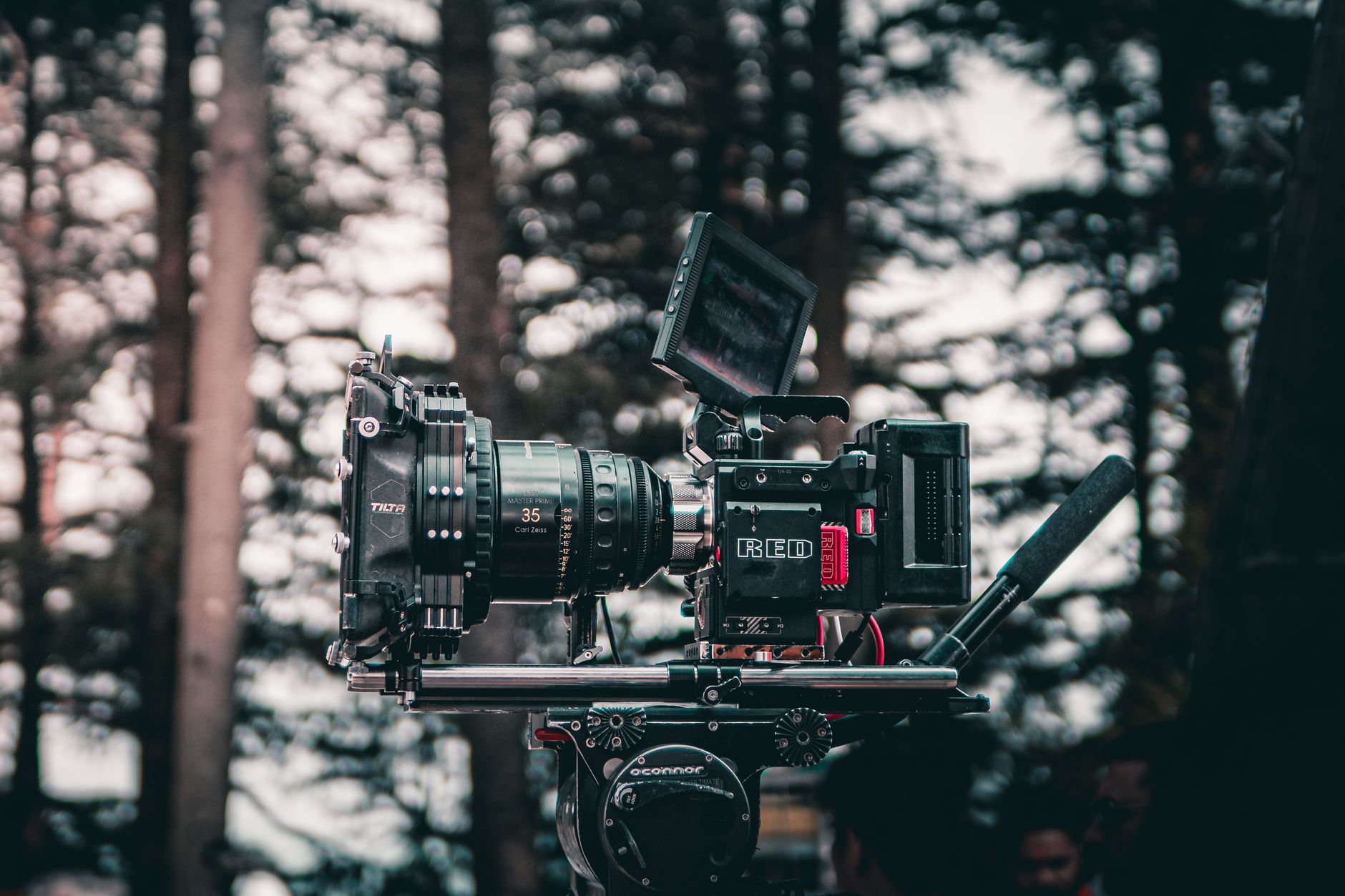 Close up camera lens showing production set elements blurred